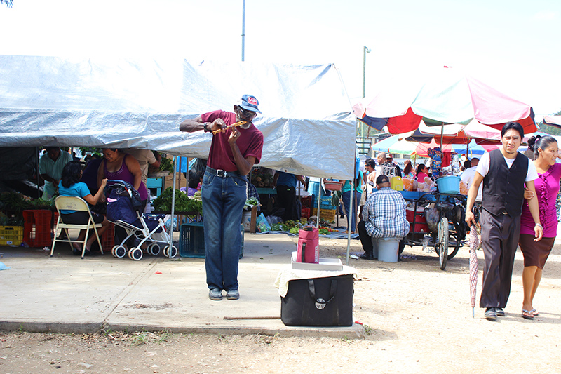 A Local Musician playing his flute at the San Ignacio Market Day