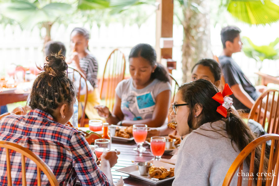 belize Christmas caroling 2018 kids eating at guava limb restaurant