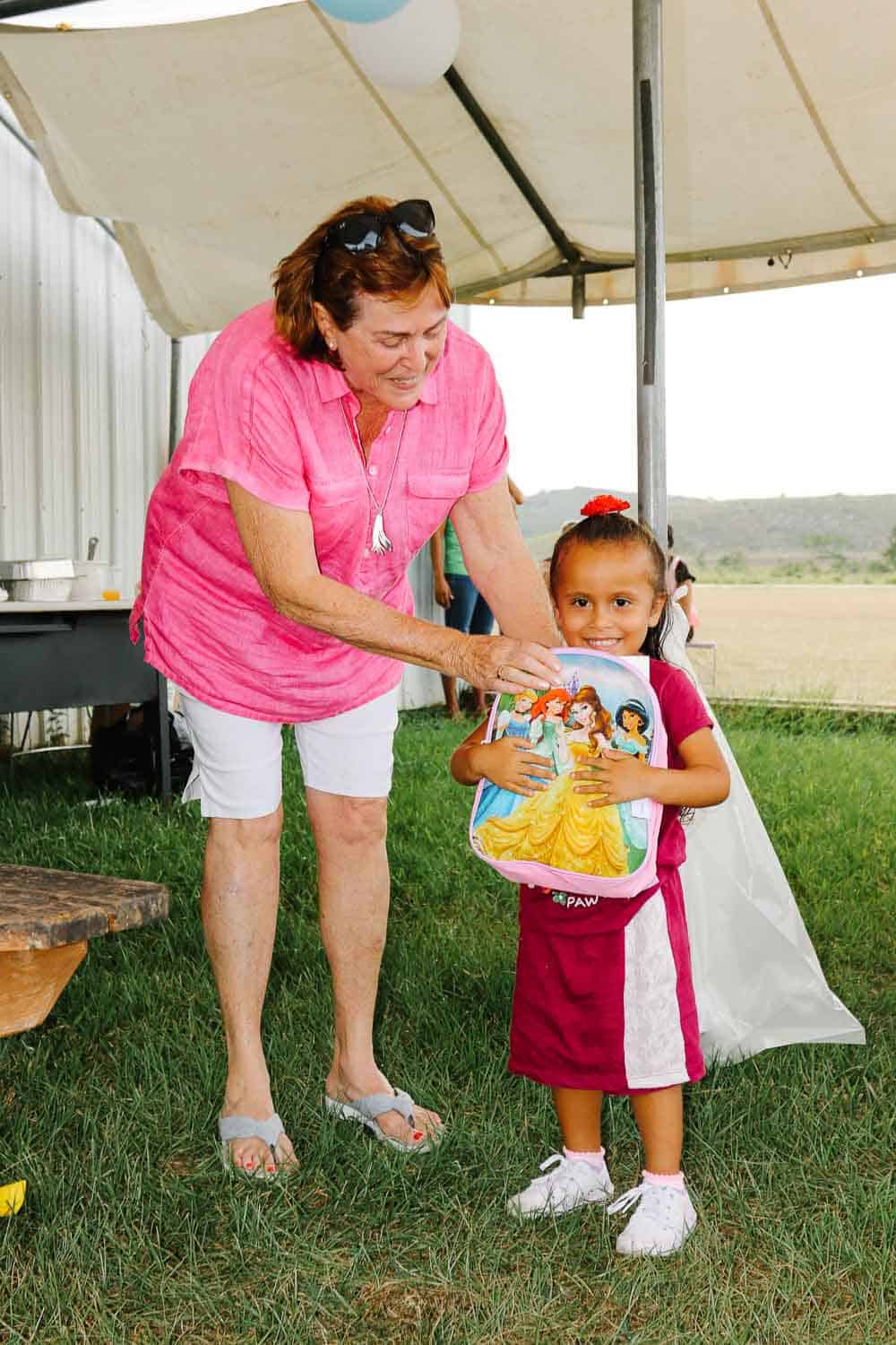 chaa creek corozalito funday Lucy fleming delivering school bag to little girl