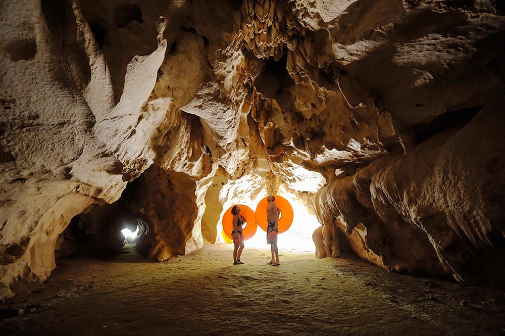 belize cave tubing romantic activities couple in cave with tubes