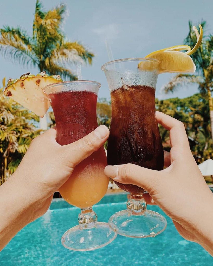 belize romantic getaways couple cheers with cocktail rum