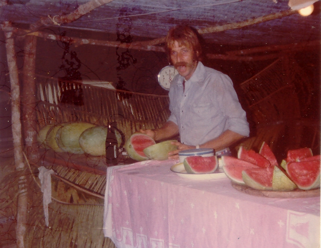 Mick Fleming selling slices of watermelons grown at Chaa Creek at one of the fairs in the early 80’s