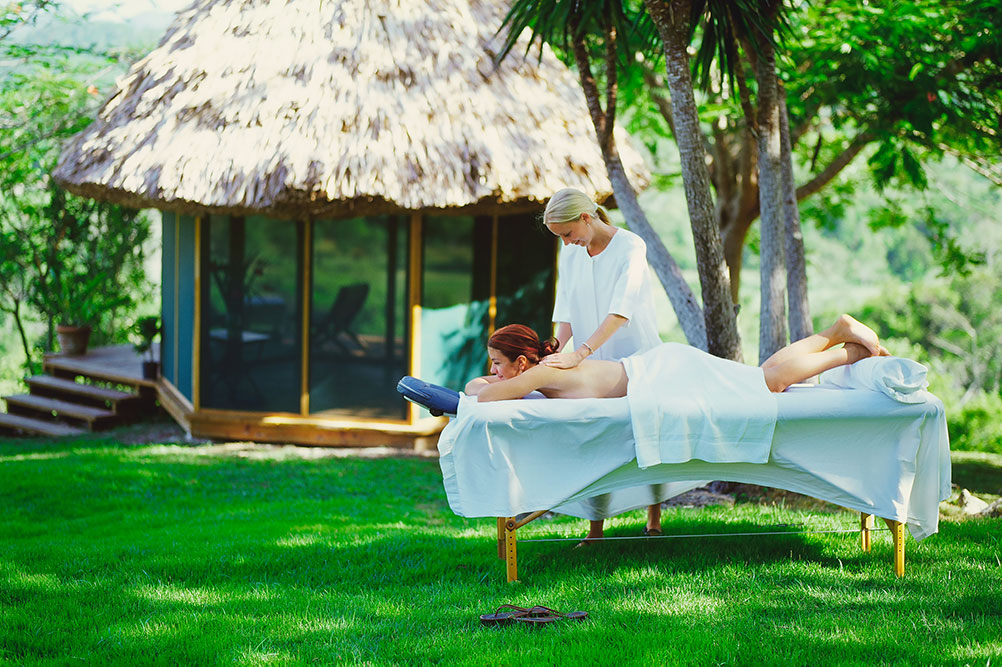 woman getting outdoor massage at chaa creek hilltop spa