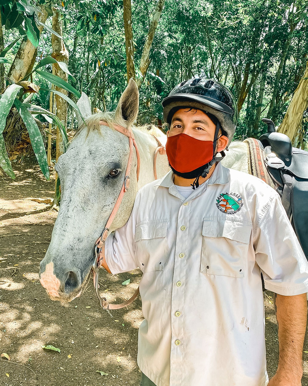 Emil a naturalist guide at Chaa Creek posing with a horse