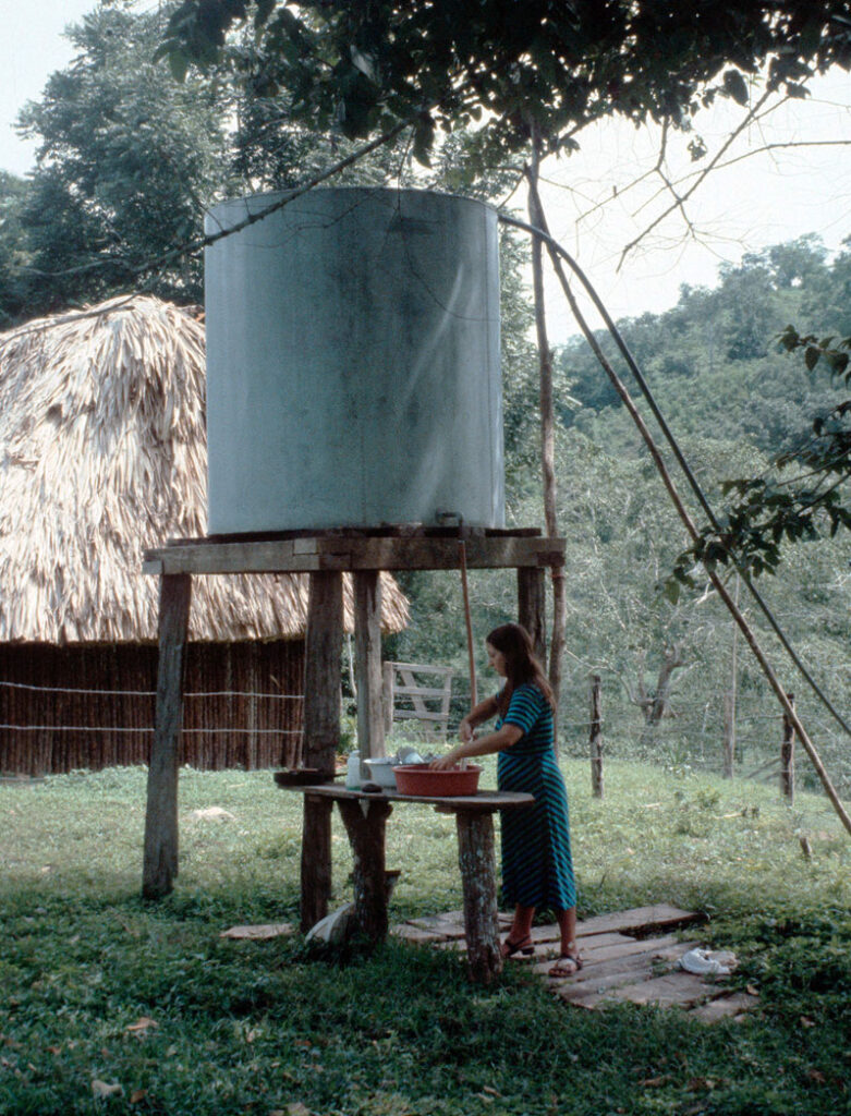 Guest Katharina W washing outside of her cottage in early days at Chaa Creek