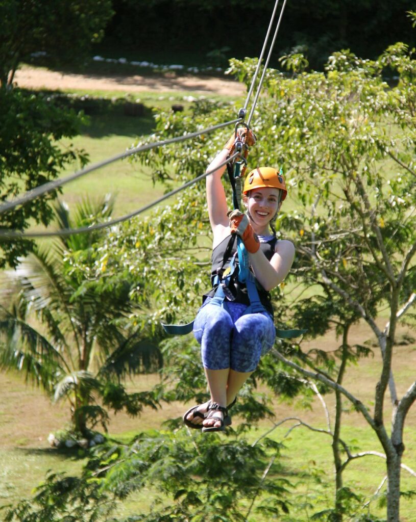 young kid ziplining in belize on family vacation