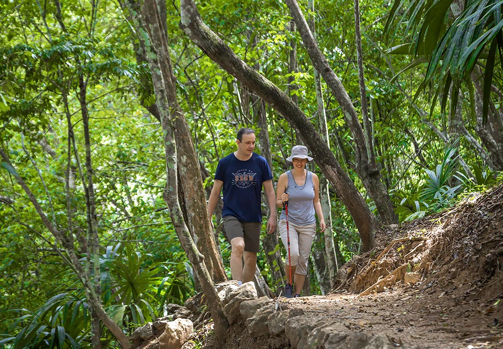 couple hiking private nature reserve in belize at chaa creek